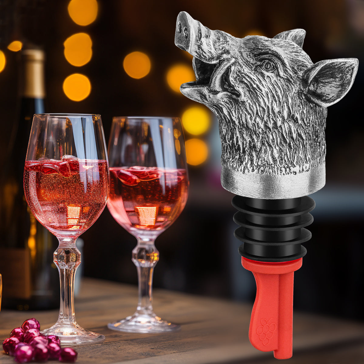 Dark Silver wild boar head wine pourer beside two glasses of rose wine