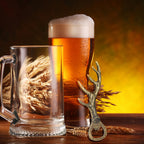 Bronze deer antler bottle opener beside a beer mug