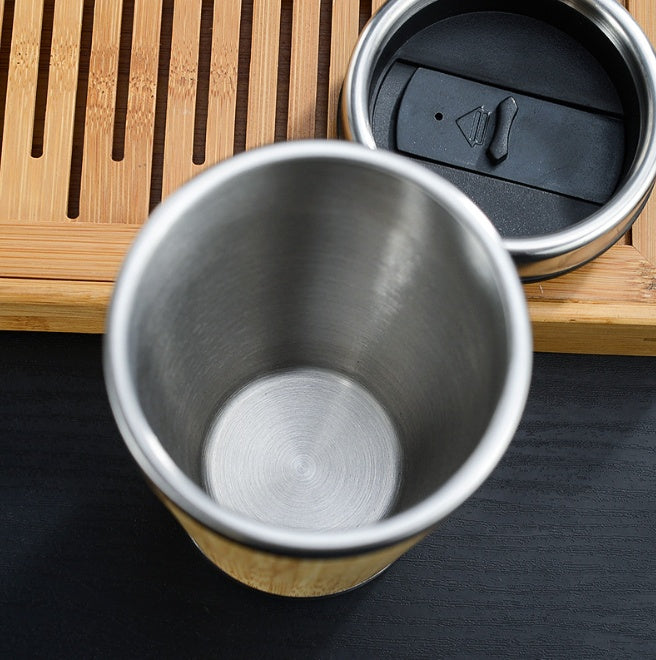 Top-down view of two bamboo cups showing the stainless steel inner and lids