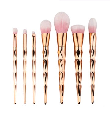 Makeup brushes with pastel bristles and iridescent handles standing upright