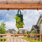 Hanging grow bag with strawberries growing from it on a balcony rail