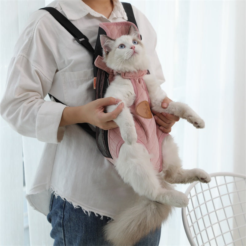 Woman carrying a cat in a coral pink front carrier backpack