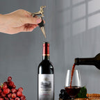 Hand placing a dachshund wine stopper into a bottle