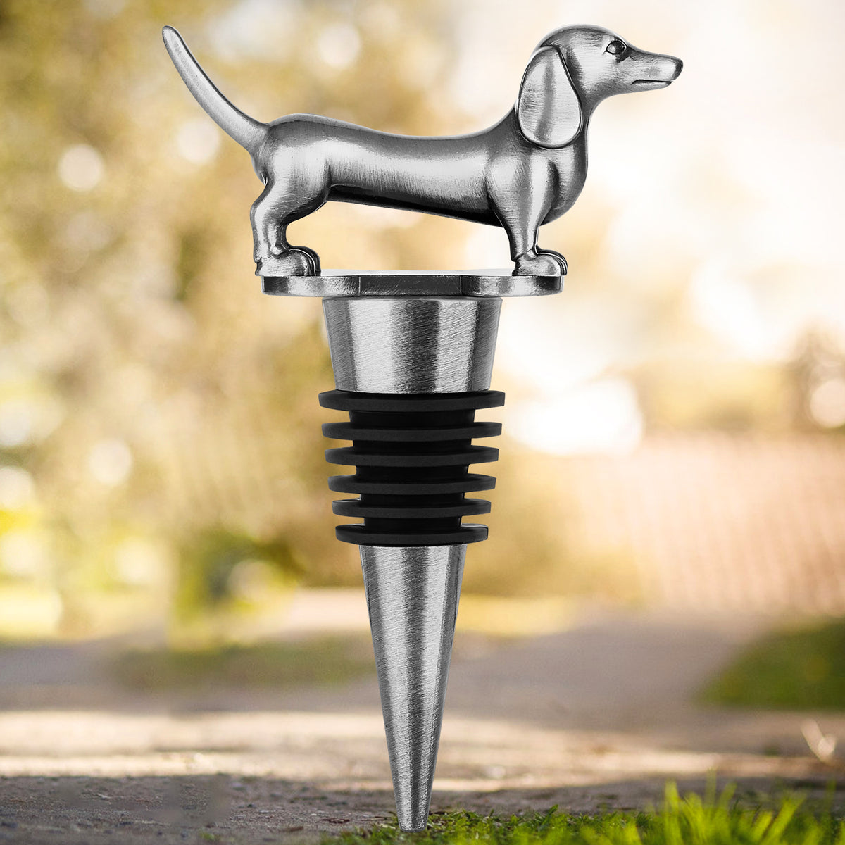 Dark Silver dachshund wine stopper on an outdoor path