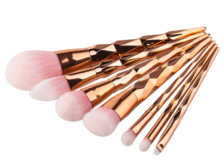 Close-up of pastel green, pink and purple brush heads