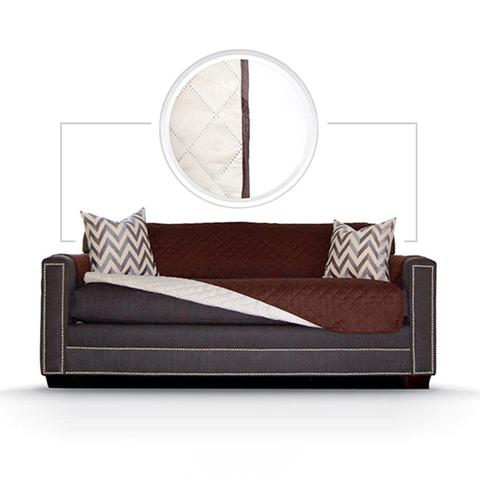 Reversible quilted sofa cover turned back to show the coffee side and the cream reverse side
