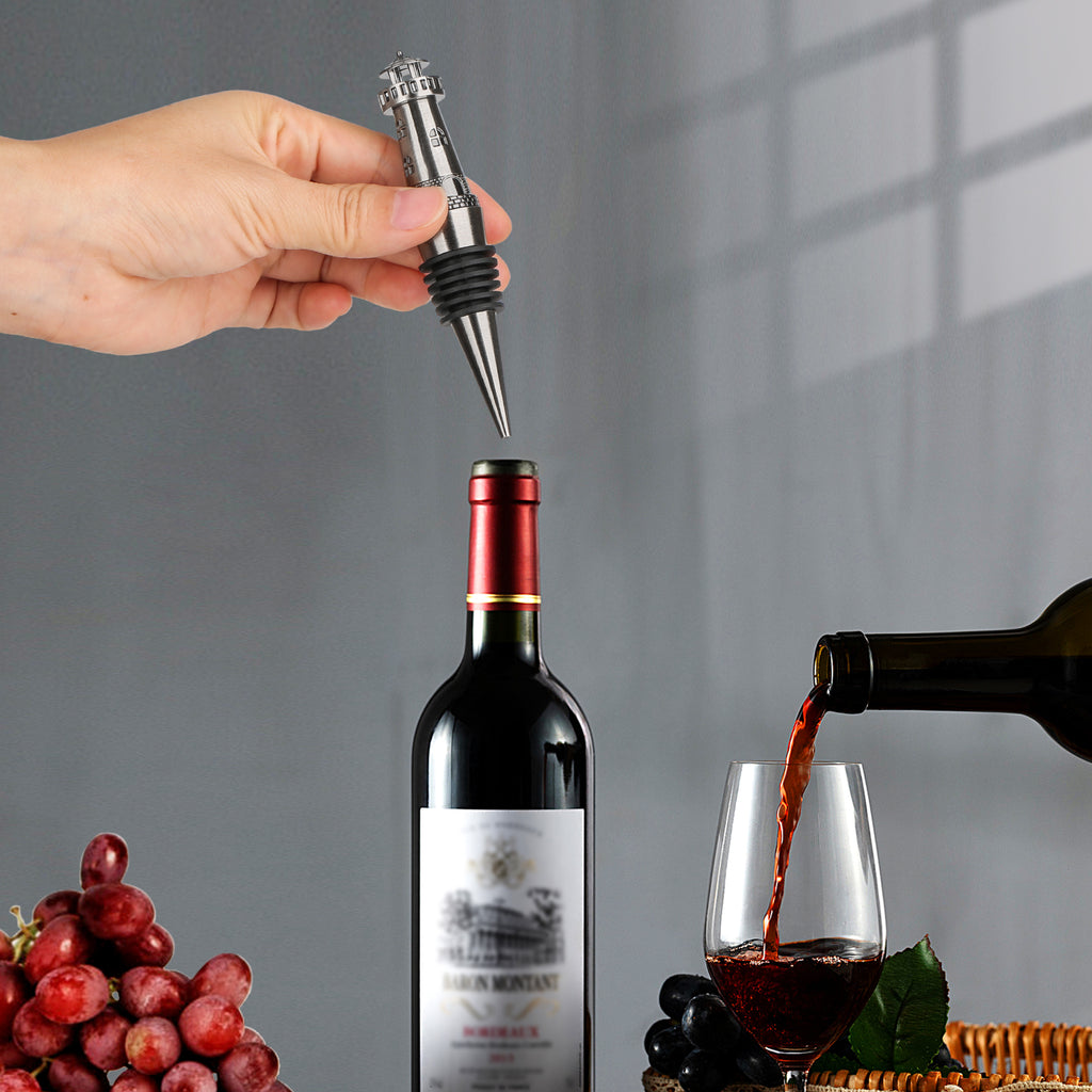 Hand placing a Dark Silver lighthouse wine stopper into a bottle