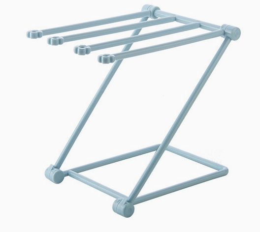 Folding dish cloth rack by a kitchen sink with a cloth hanging on it