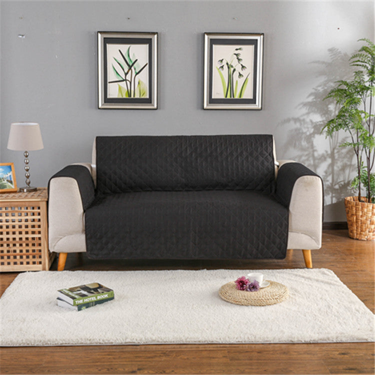 Black quilted sofa cover on a two-seat sofa