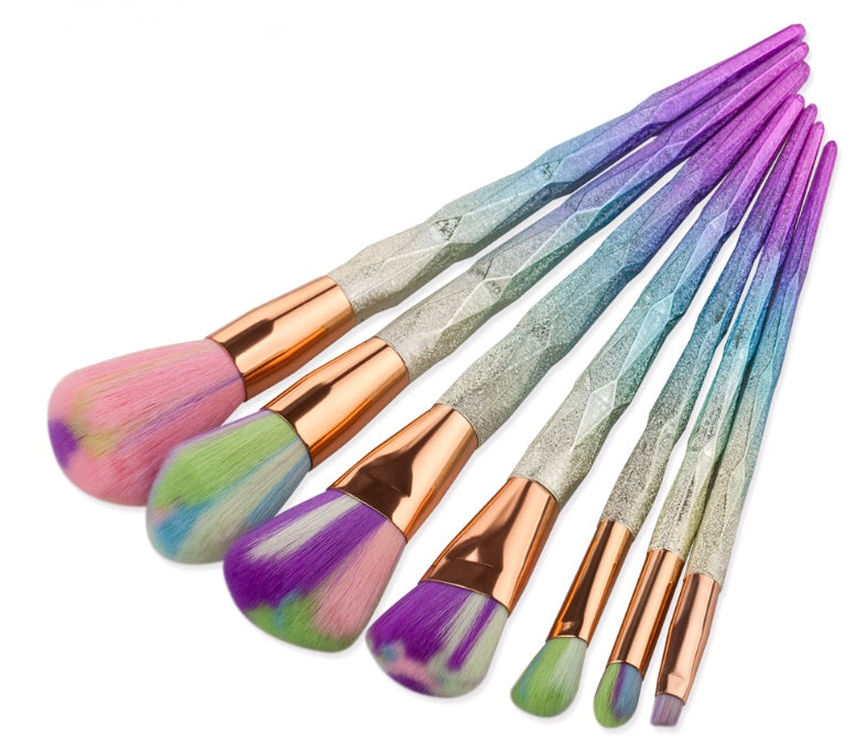 Close-up of purple and white brush heads on blue faceted handles