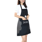 Woman wearing a black kitchen apron with a front pocket