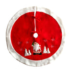 White-border Christmas tree skirt with red centre, showing the tie closures and embroidered Santa with snowflakes