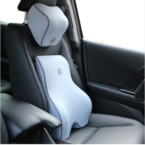 Gray back support and neck pillow set installed in a car