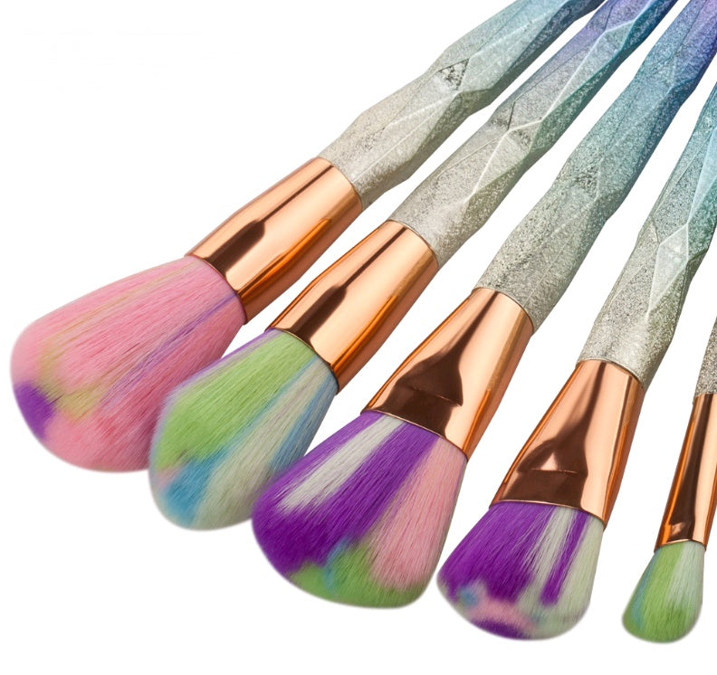 Rose-gold makeup brush set with pink bristles fanned out