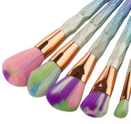 Rose-gold makeup brush set with pink bristles fanned out