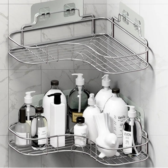 Two-tier corner shower shelves in a tiled bathroom holding bottles and soap
