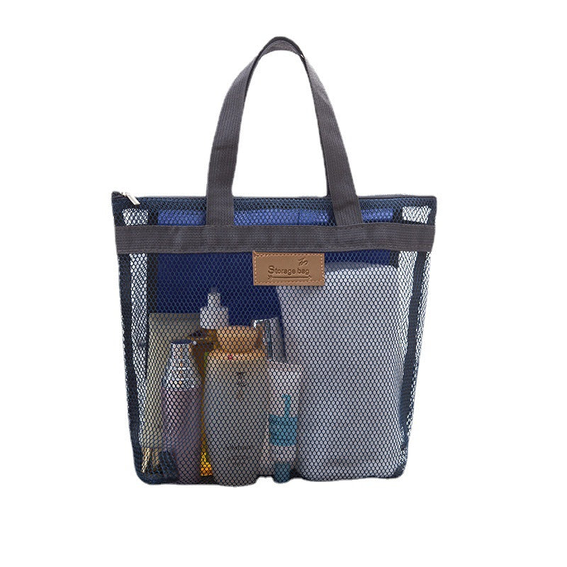 Navy blue mesh tote bag with toiletries visible through the mesh