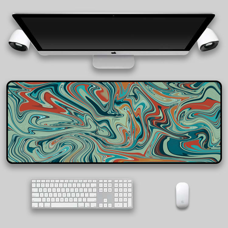 Black, grey and white swirl desk mat on a desk setup