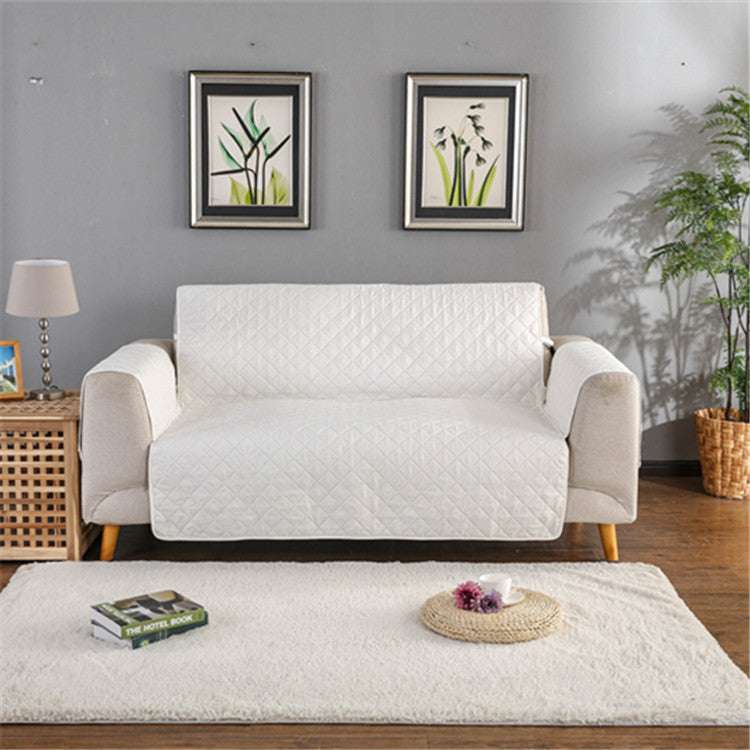 White quilted sofa cover on a sofa