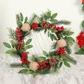 Greenery Christmas wreath with pine cones, red berries and leaves on a marble surface