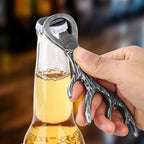 Hand opening a beer bottle with a Dark Silver deer antler bottle opener