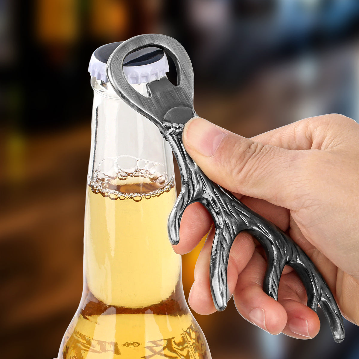 Hand opening a beer bottle with a Dark Silver deer antler bottle opener