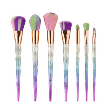 Blue faceted brush handles lined up beside purple brush heads