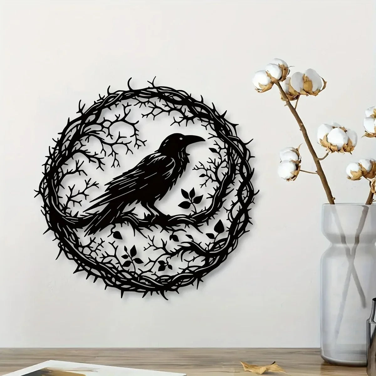 Black iron raven wall art on a living room wall
