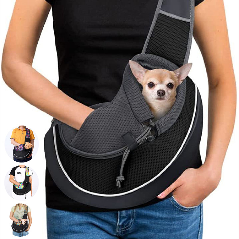 Woman wearing a black pet sling carrier with a small dog looking out of the opening