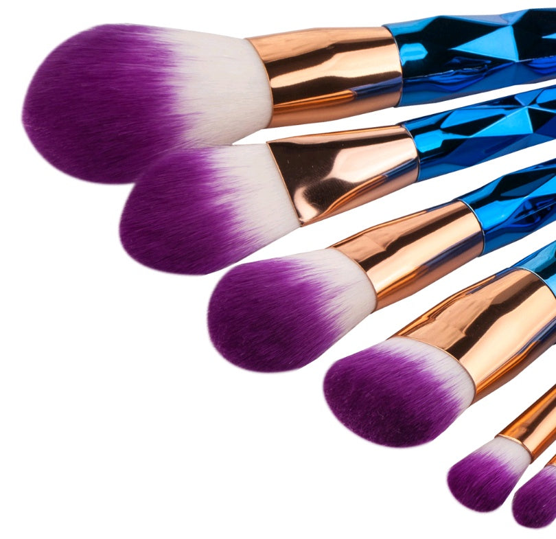 Rose-gold handled makeup brushes standing upright