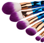 Rose-gold handled makeup brushes standing upright