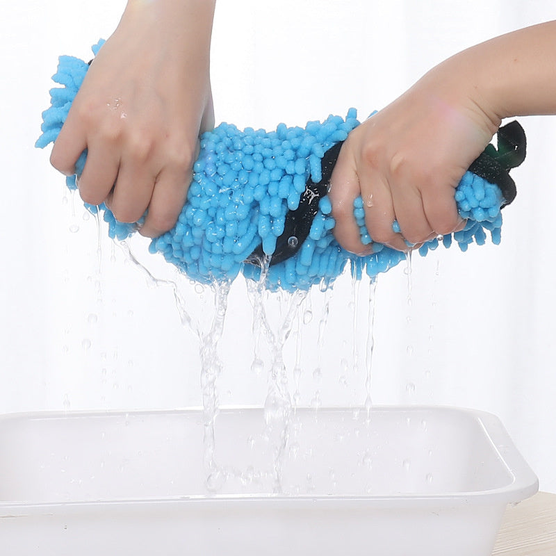 Hands wringing a blue chenille pet towel over a water basin