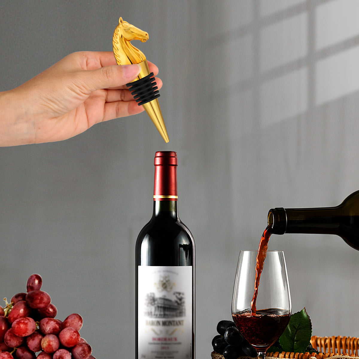 Hand placing a Golden horse head wine stopper into a bottle