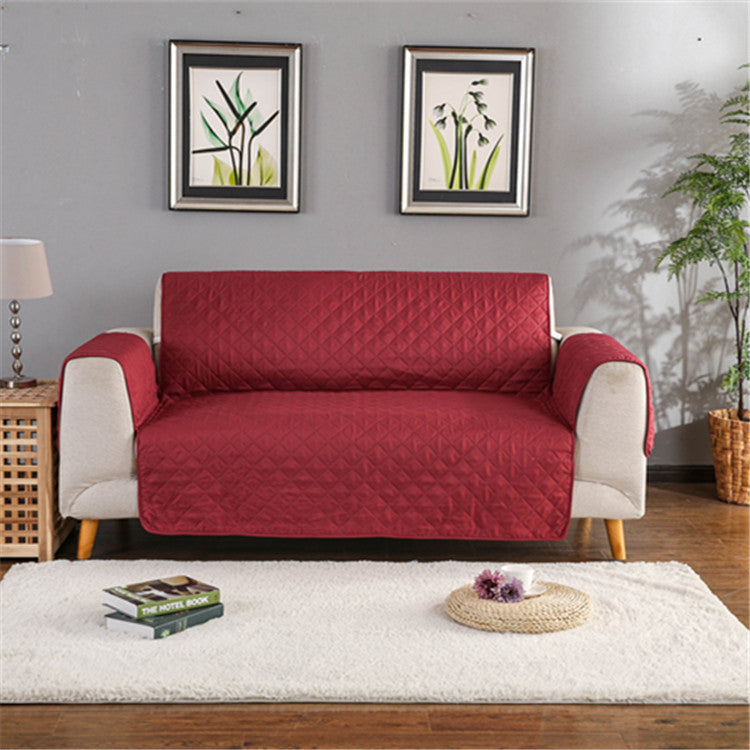 Red quilted sofa cover on a two-seat sofa