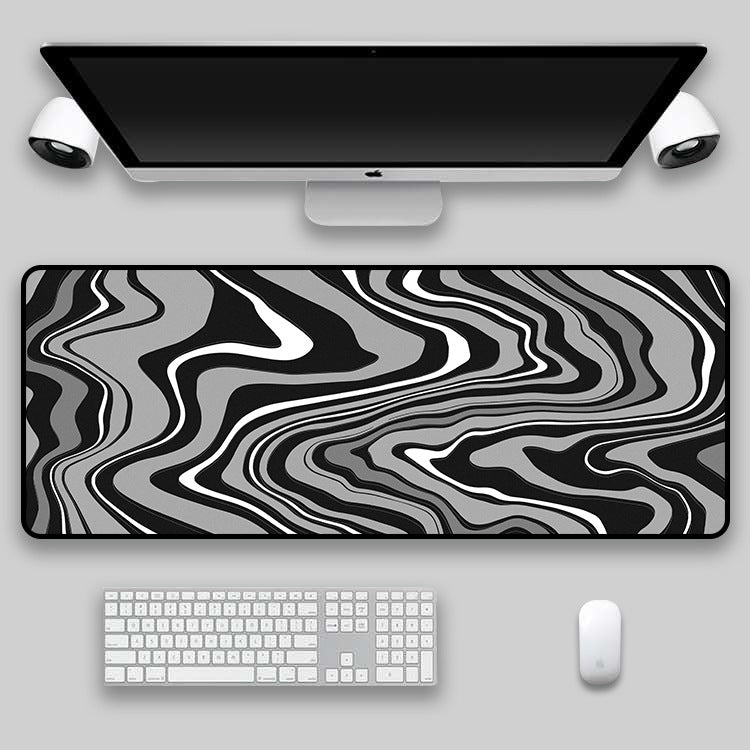 Pink, blue and white swirl desk mat on a desk setup