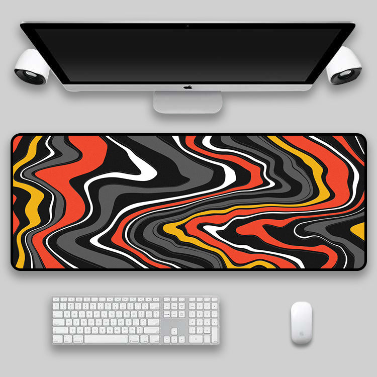 Teal, coral and black swirl desk mat on a desk setup