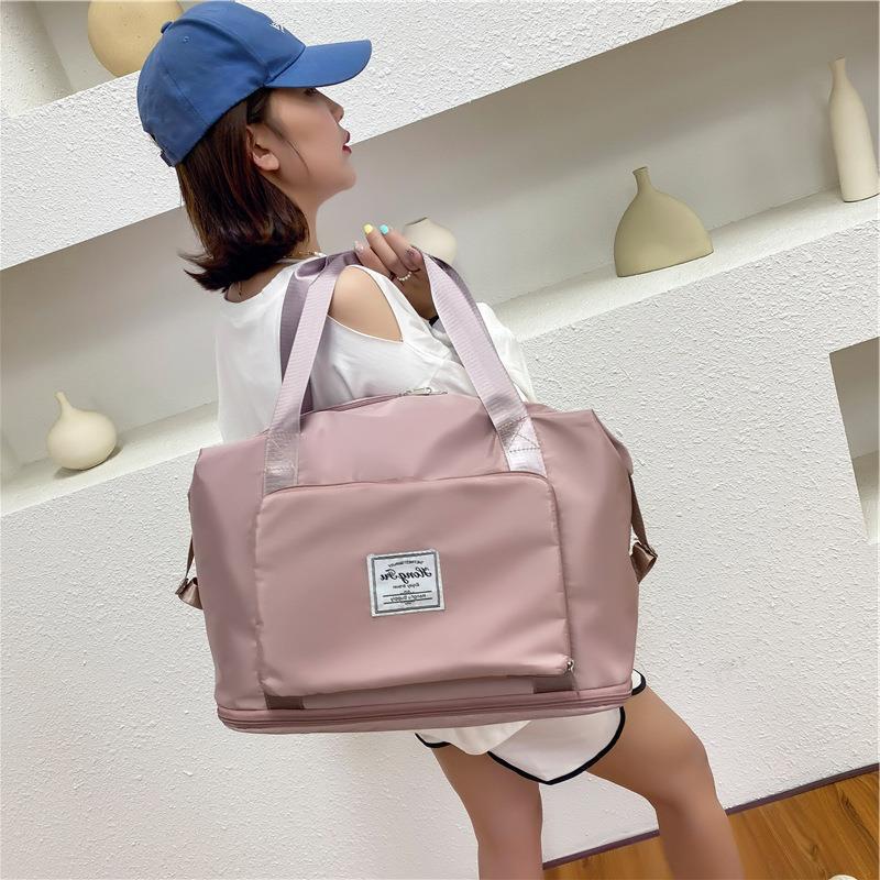 Woman carrying a pink foldable duffel bag