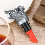 Dark Silver wild boar head wine pourer on a plate beside a glass
