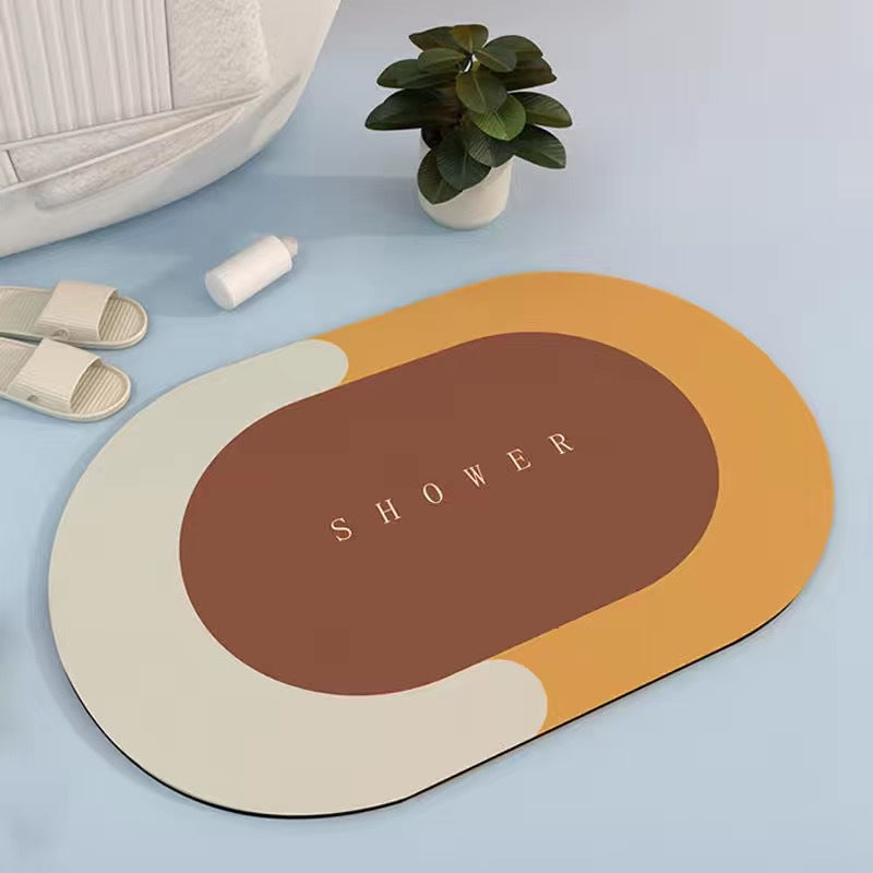 Orange, cream and brown oval bath mat on a pale blue floor beside slippers and a potted plant