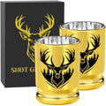 Two gold deer head shot glasses in front of a black gift box