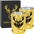 Two gold deer head shot glasses in front of a black gift box