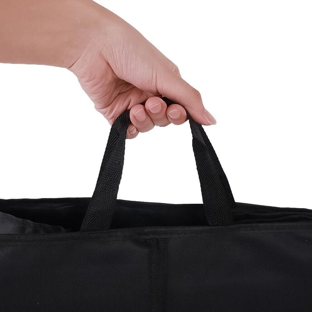 Hand holding the black carry handle of a fabric trunk organizer