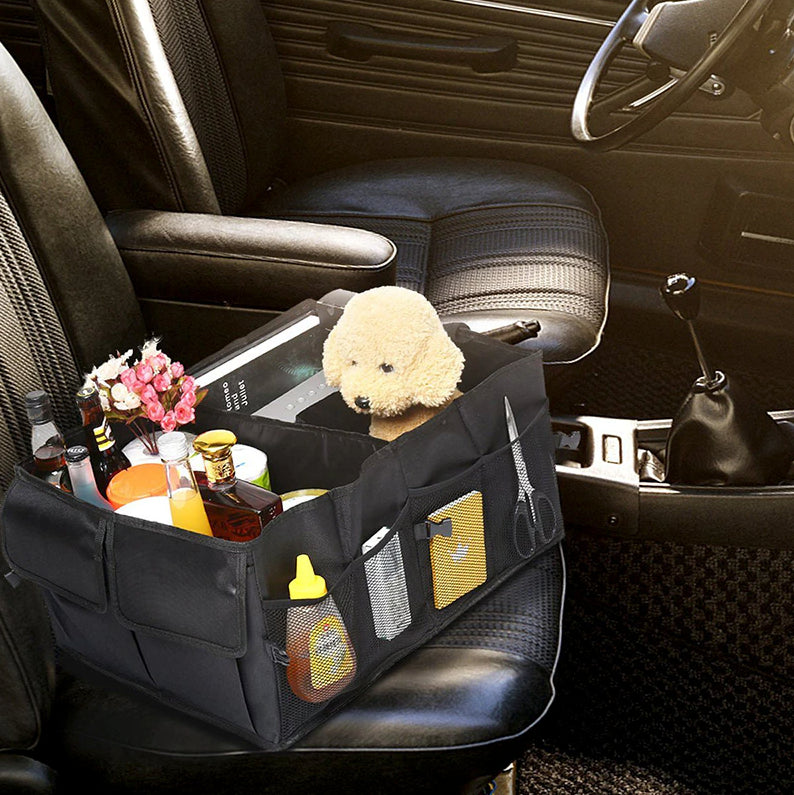 Black collapsible organizer on a car back seat holding bottles and small items